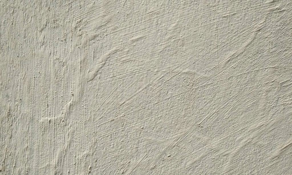 Bubbling and peeling paint caused by damp on a Constantia boundary wall